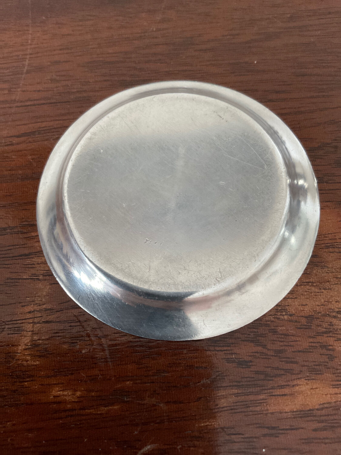 Cup and silver metal saucer