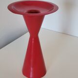 Vintage design candlestick in red metal in the shape of an hourglass