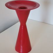Vintage design candlestick in red metal in the shape of an hourglass