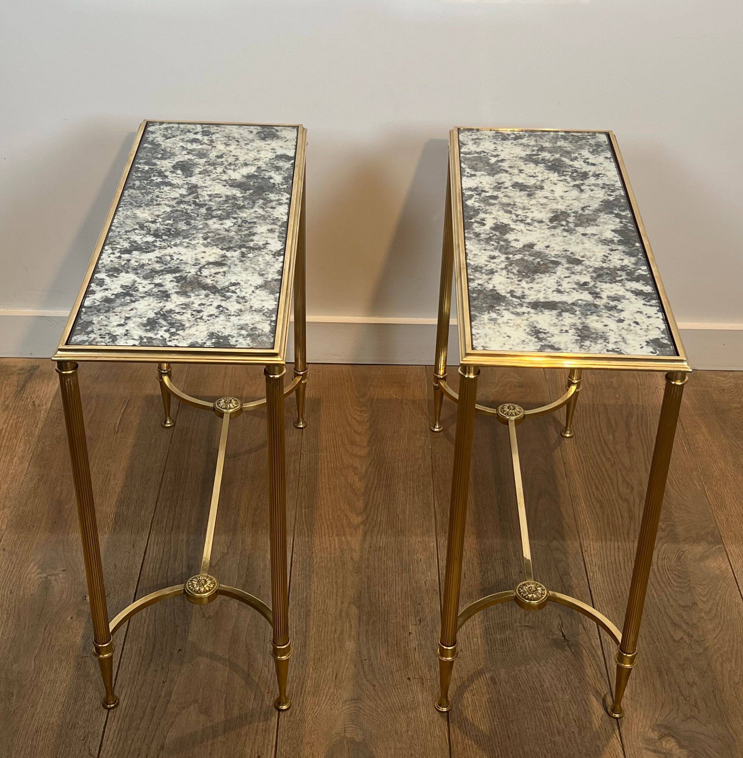 Pair of brass and antique mirror side tables from the Baguès house.