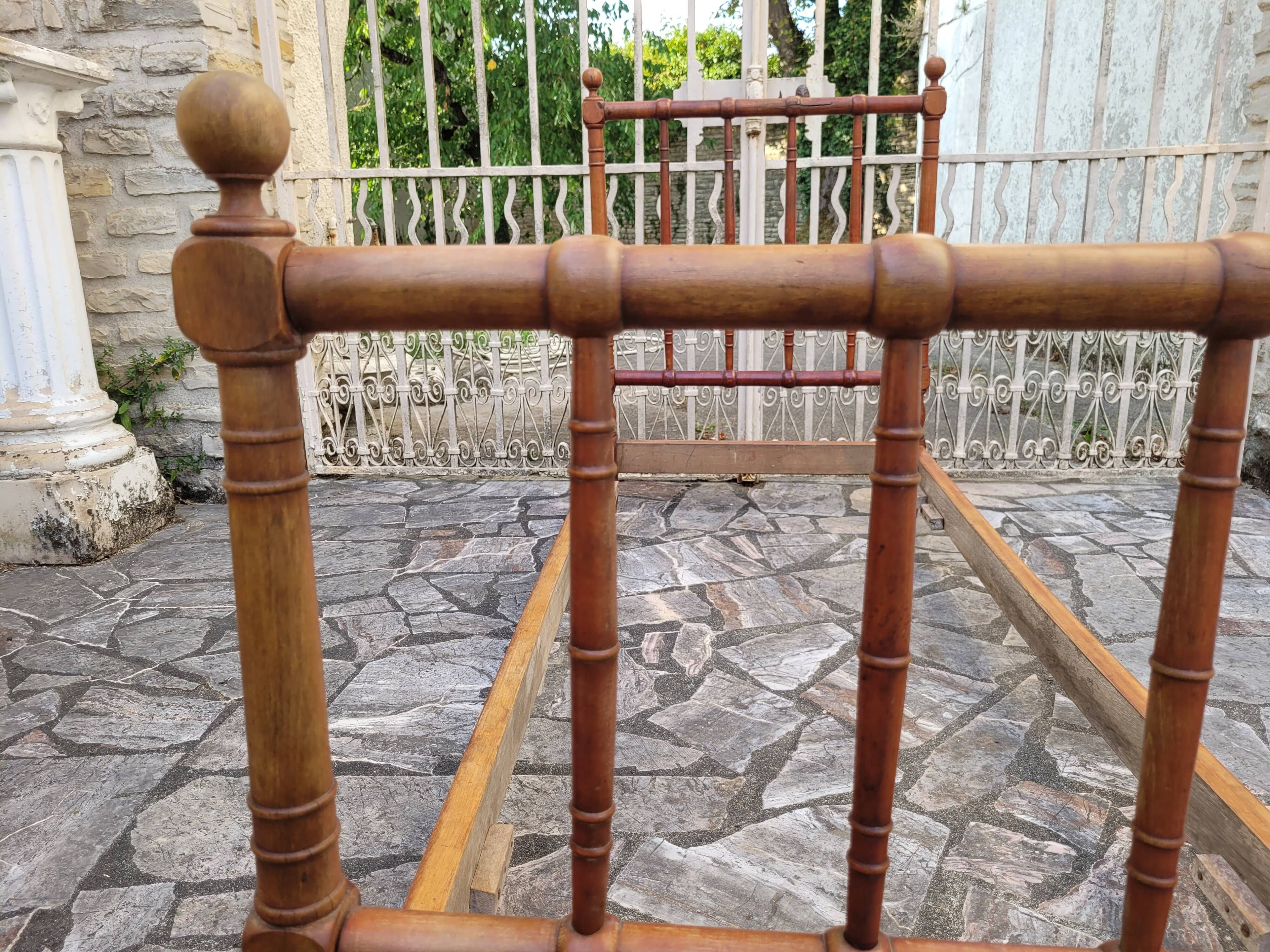 Child's bed or vintage rest bed made of solid cherry wood in a bamboo style.