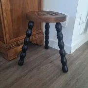 Brown and black wooden tripod stool