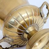 Vintage brass cache-pot on a stand with handles, classic decor.