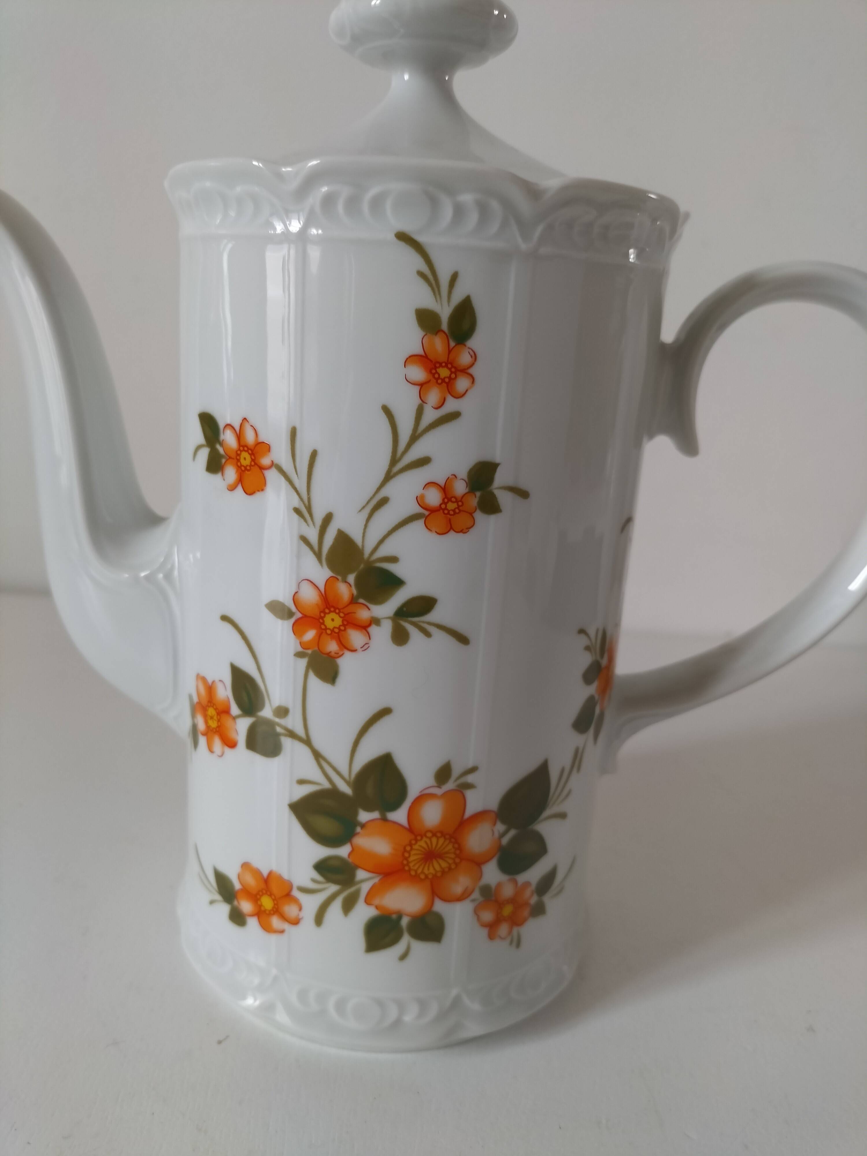 Vintage coffee pot Winterling Bavaria with orange floral decoration.