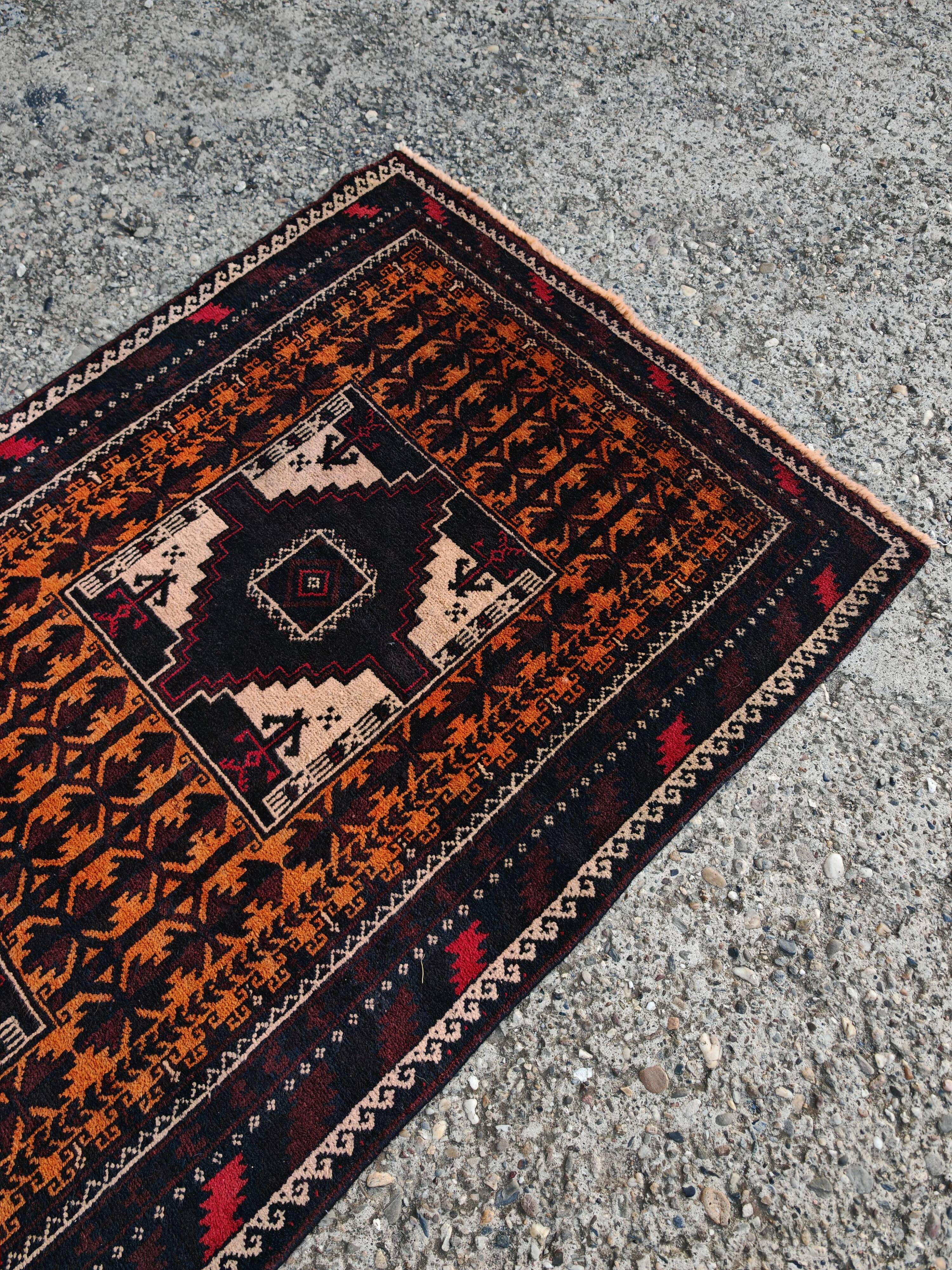 Vintage Persian Baluch rug, hand-knotted wool, 1970.