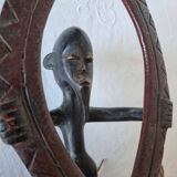 A large Senufo mask made of colored wood, decorated with an anthropomorphic figure