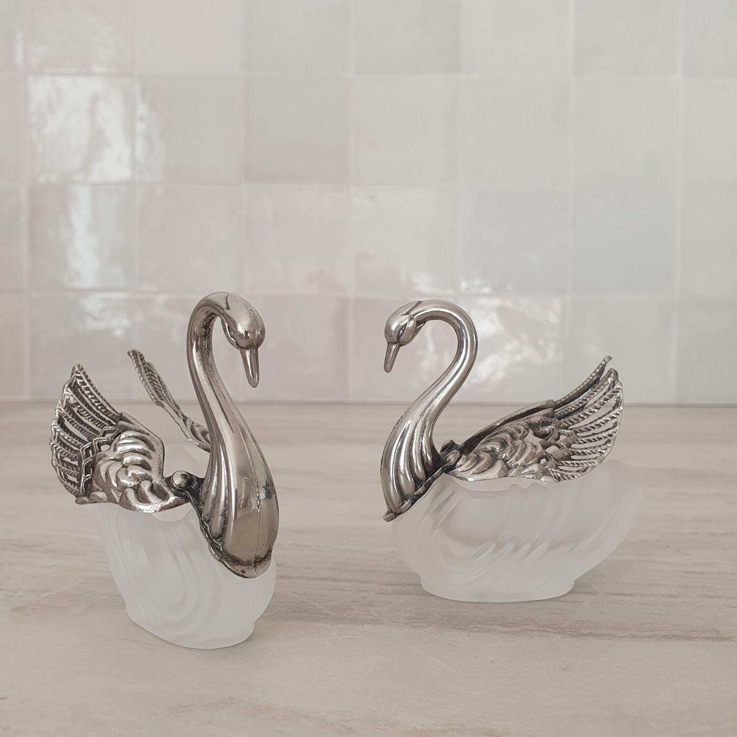 Two frosted glass swan salt cellars with silver plating.