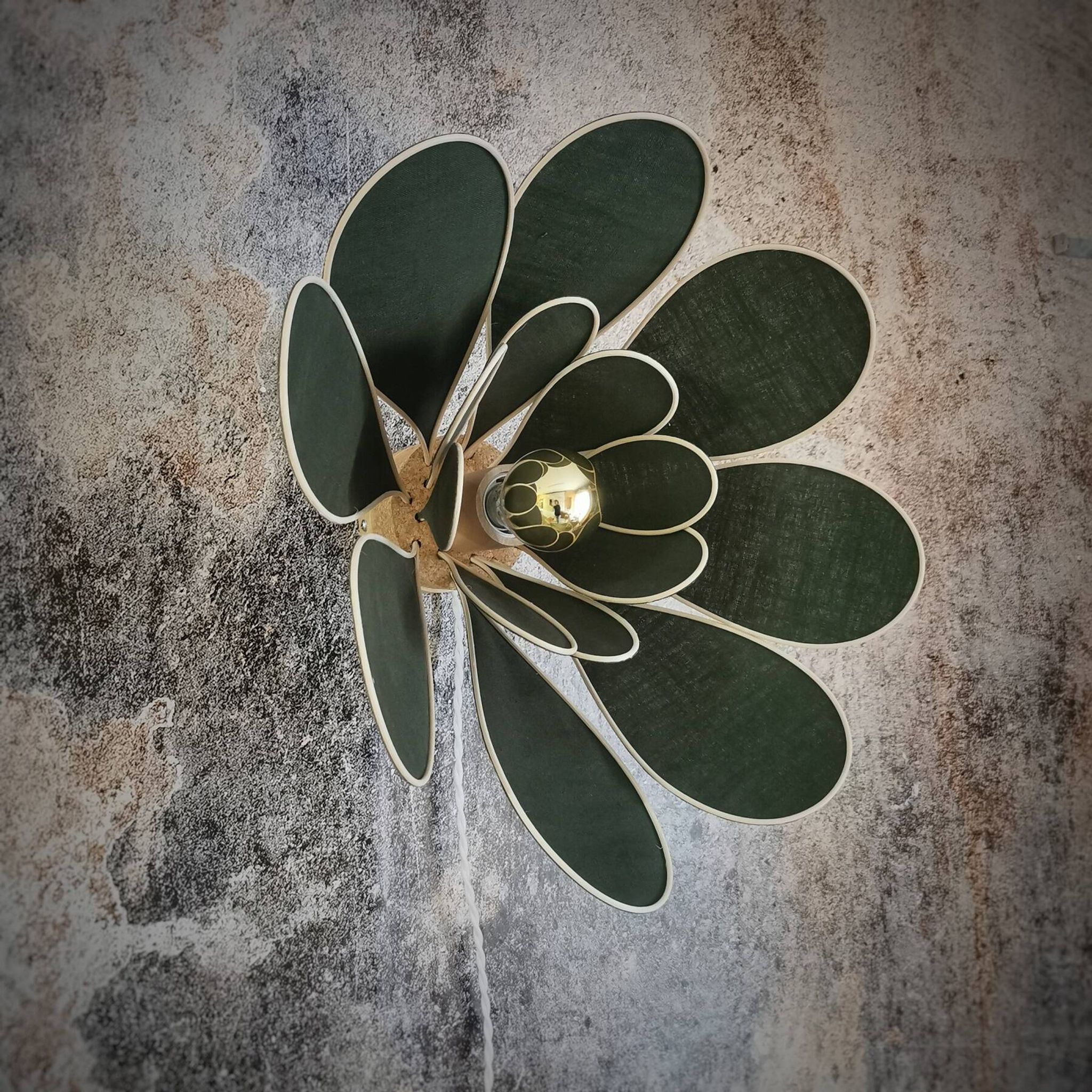 Flower wall light made of rattan and fir green linen petals