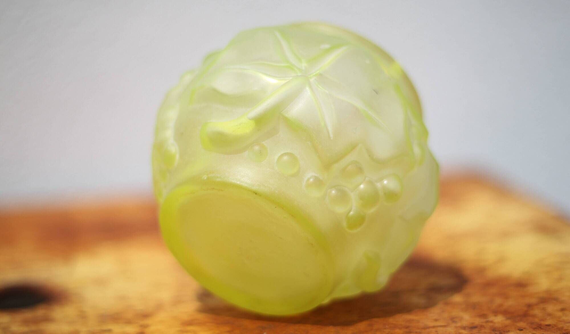 Fluorescent yellow ball vase with vine leaf patterns