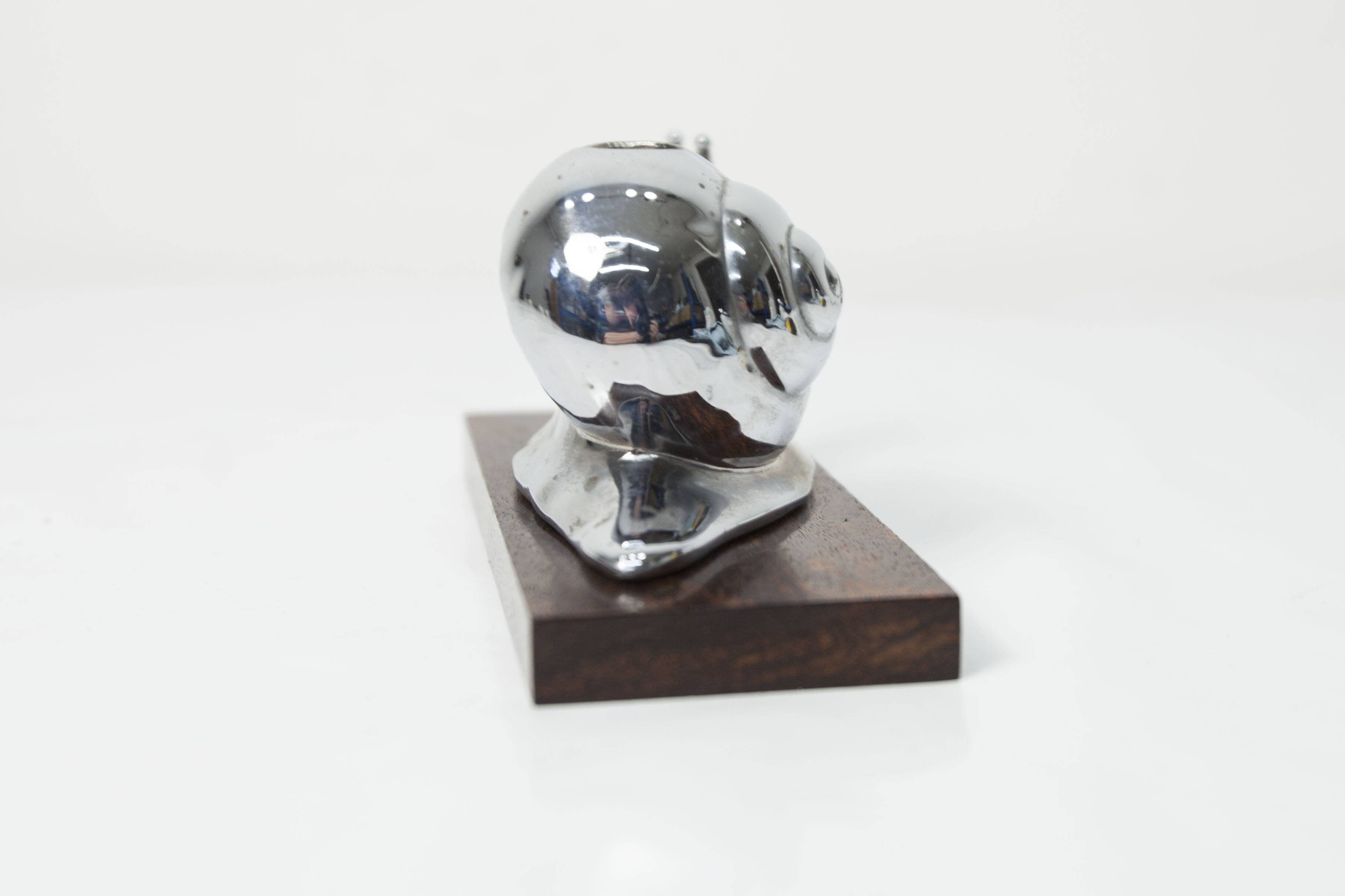 Silver snail candlestick on a teak base 1960