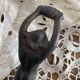 Antique cast iron coat hook with swimmer and shell basin.