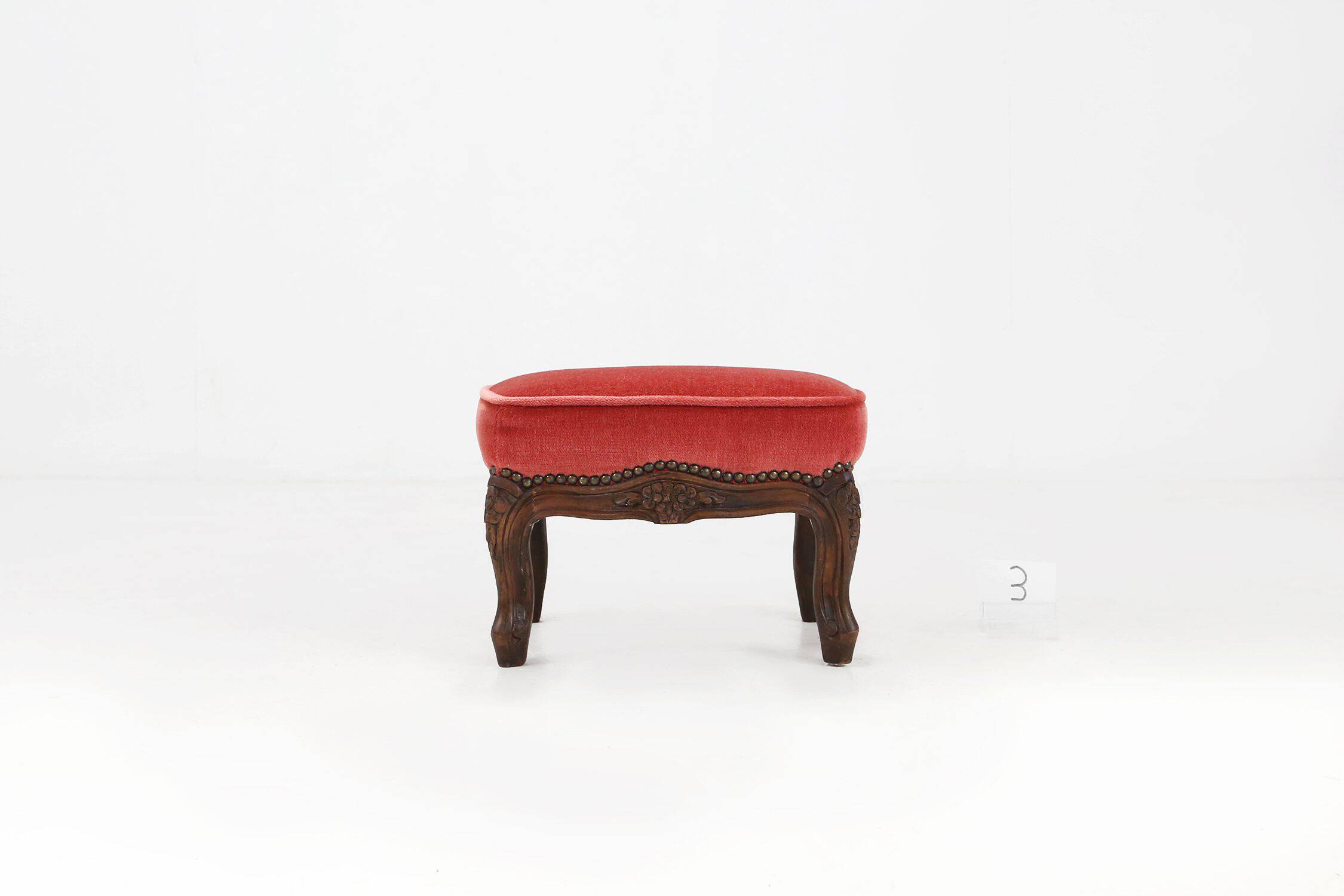 Baroque style foot stool in carved wood with coral velvet upholstery