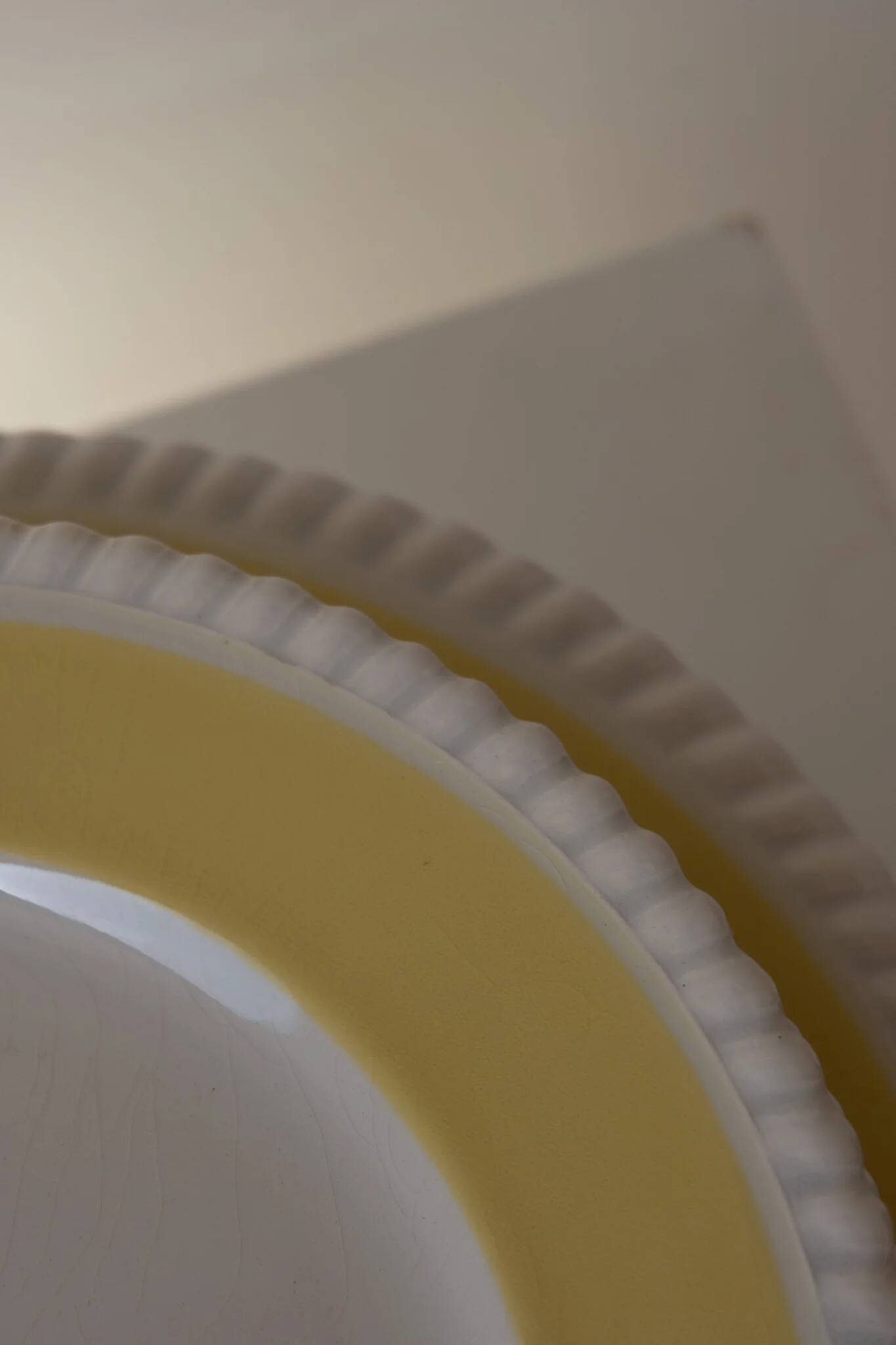 Vintage yellow butter ceramic dinnerware set with swirl border.