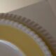 Vintage yellow butter ceramic dinnerware set with swirl border.