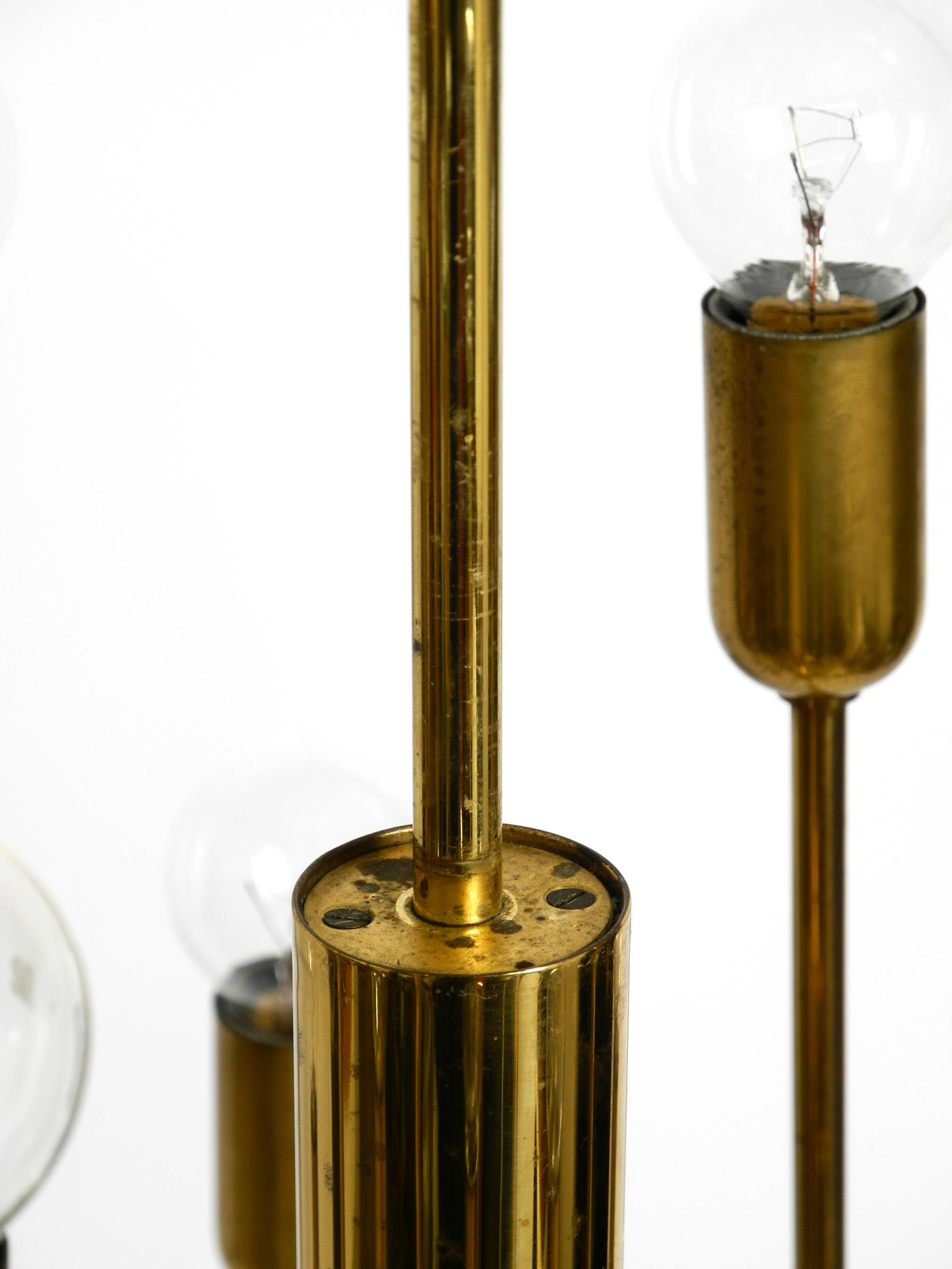 Three staged 18 arm Mid Century brass chandelier with a long brass rod