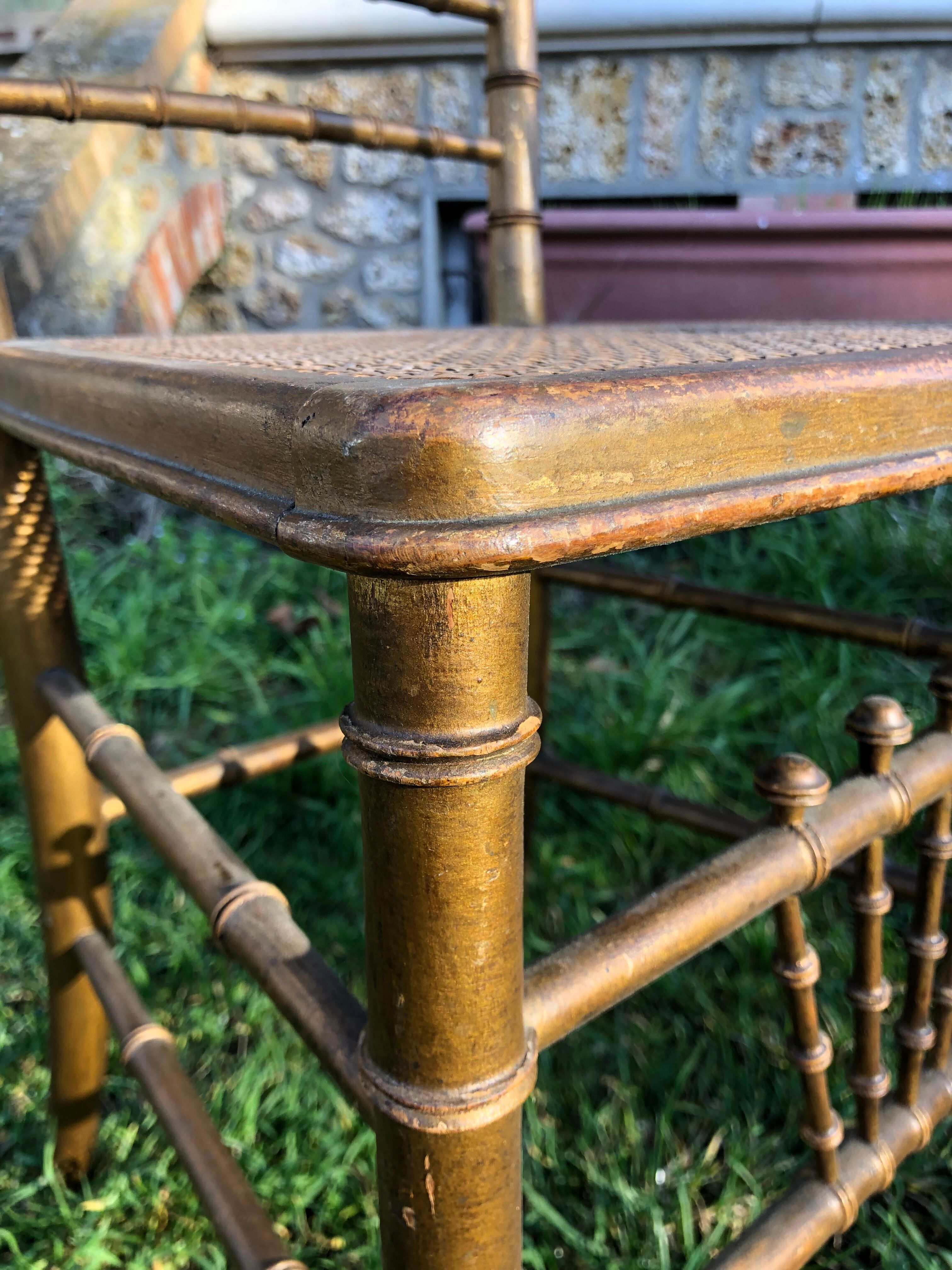 Pair of caned chairs in gilded wood