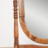 Large psychic mirror on legs with pivoting oval frame.