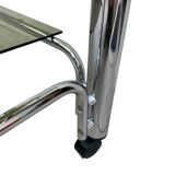 Smoked glass and chrome metal table with casters