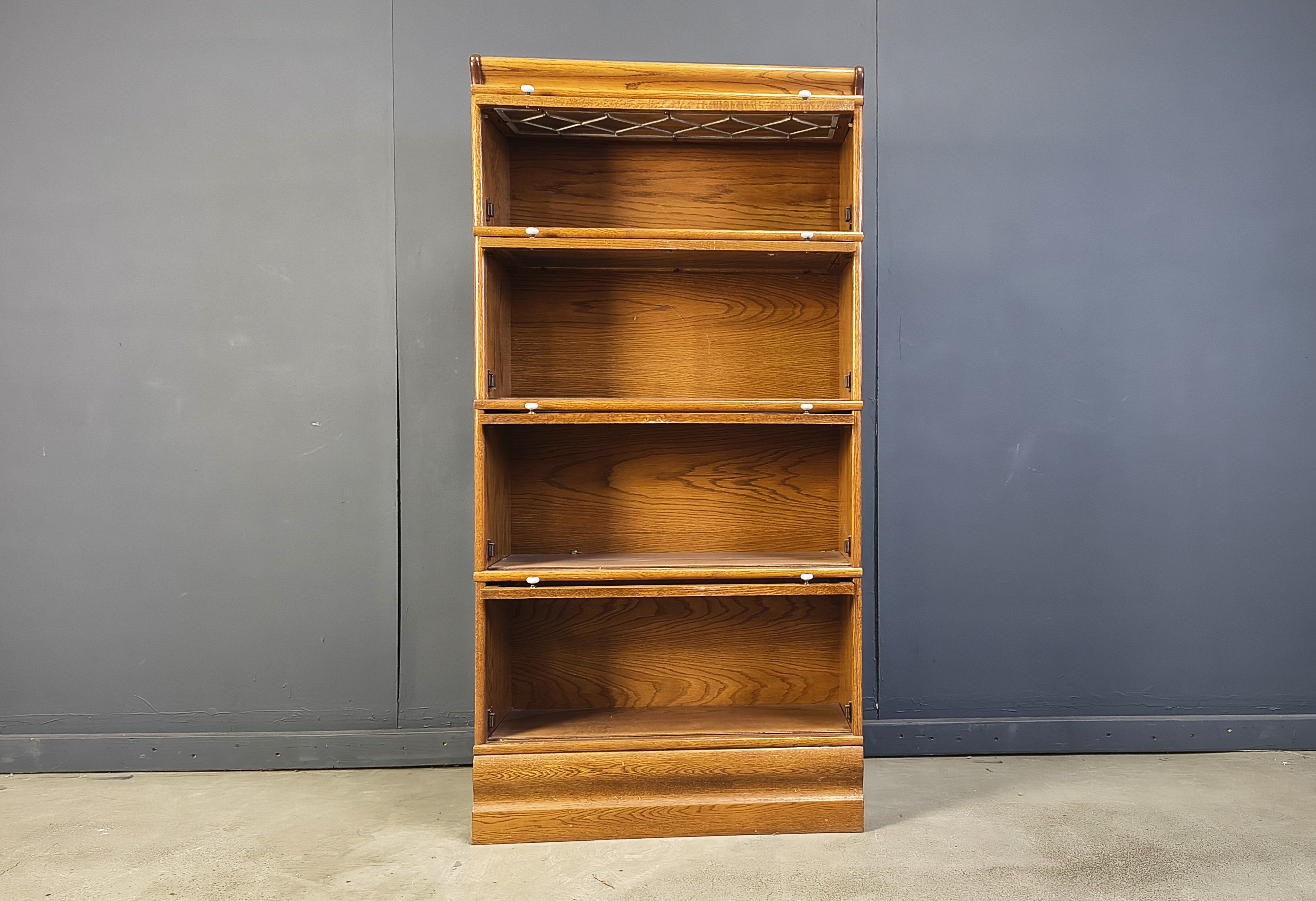 Four tier oak barrister style bookcase with leaded glass