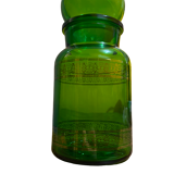 Green apothecary jar with golden patterns