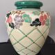 Vase in sandstone with decorations of diamonds and fruits