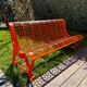 Orange pierced sheet metal bench