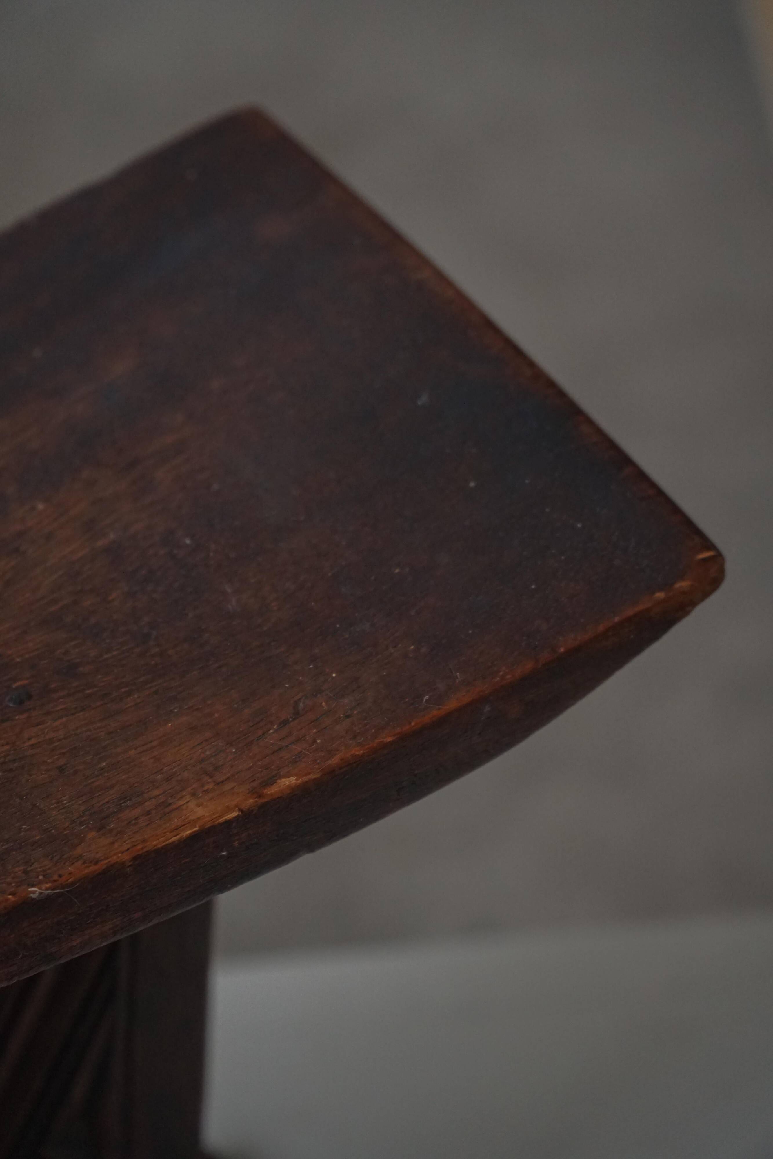 Sculptural African stool in hardwood, curved seat and architectural base, 1970s.