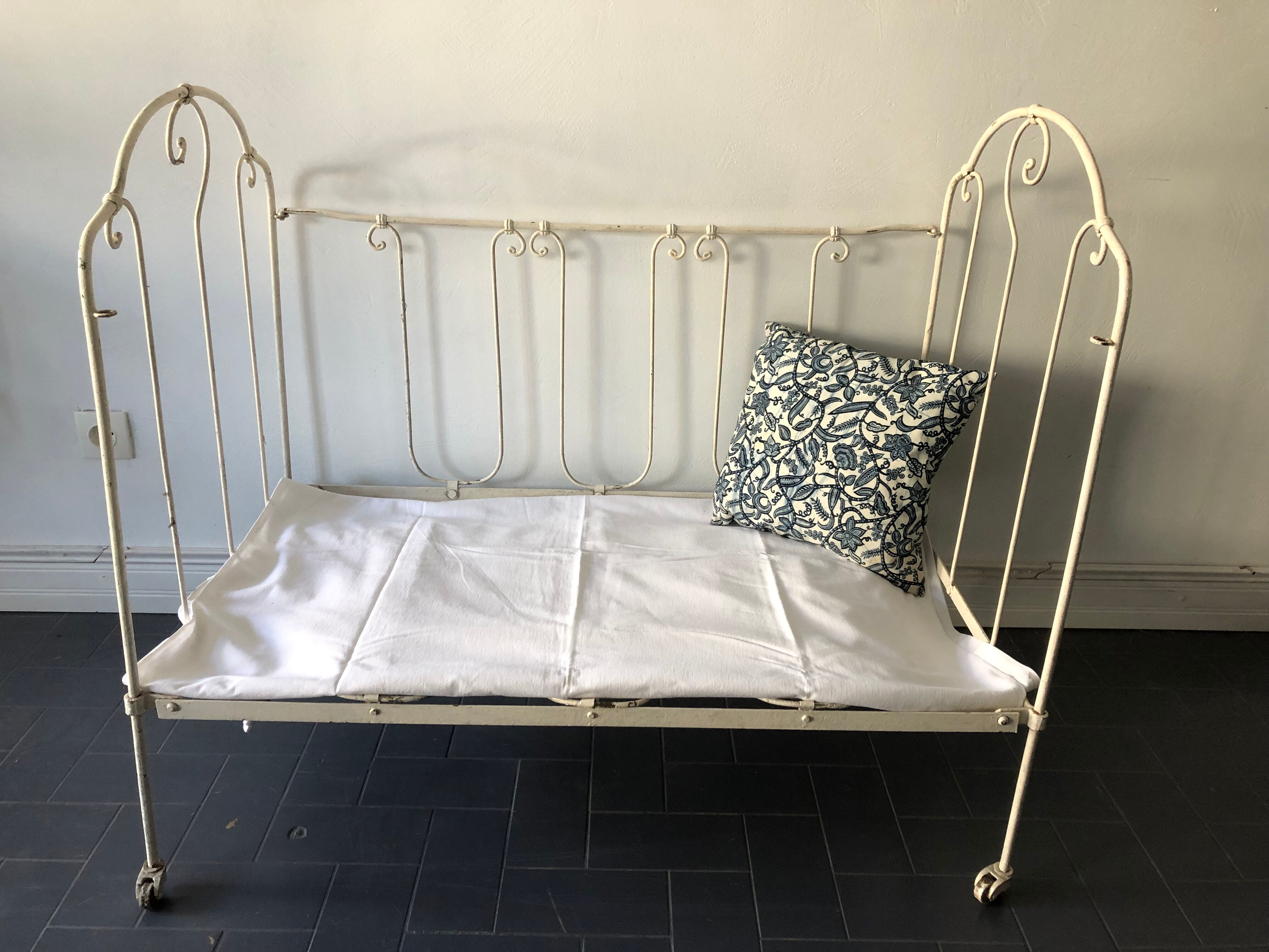 Old white wrought iron folding bed / seat
