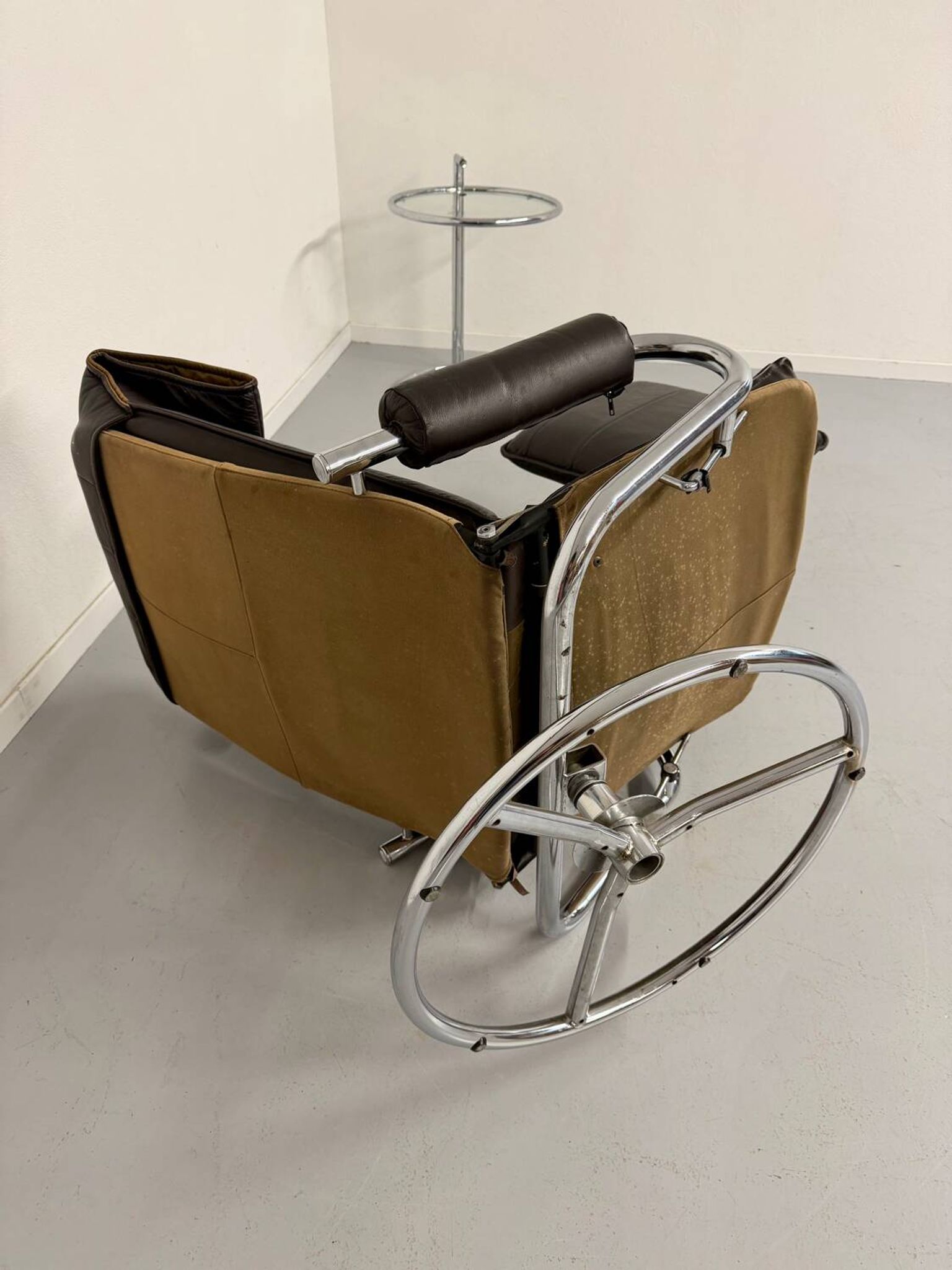 Vintage leather reclining armchair and its 1970s designer ottoman.