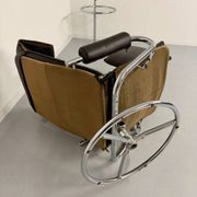 Vintage leather reclining armchair and its 1970s designer ottoman.