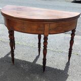 Half moon console opening on a solid walnut round table