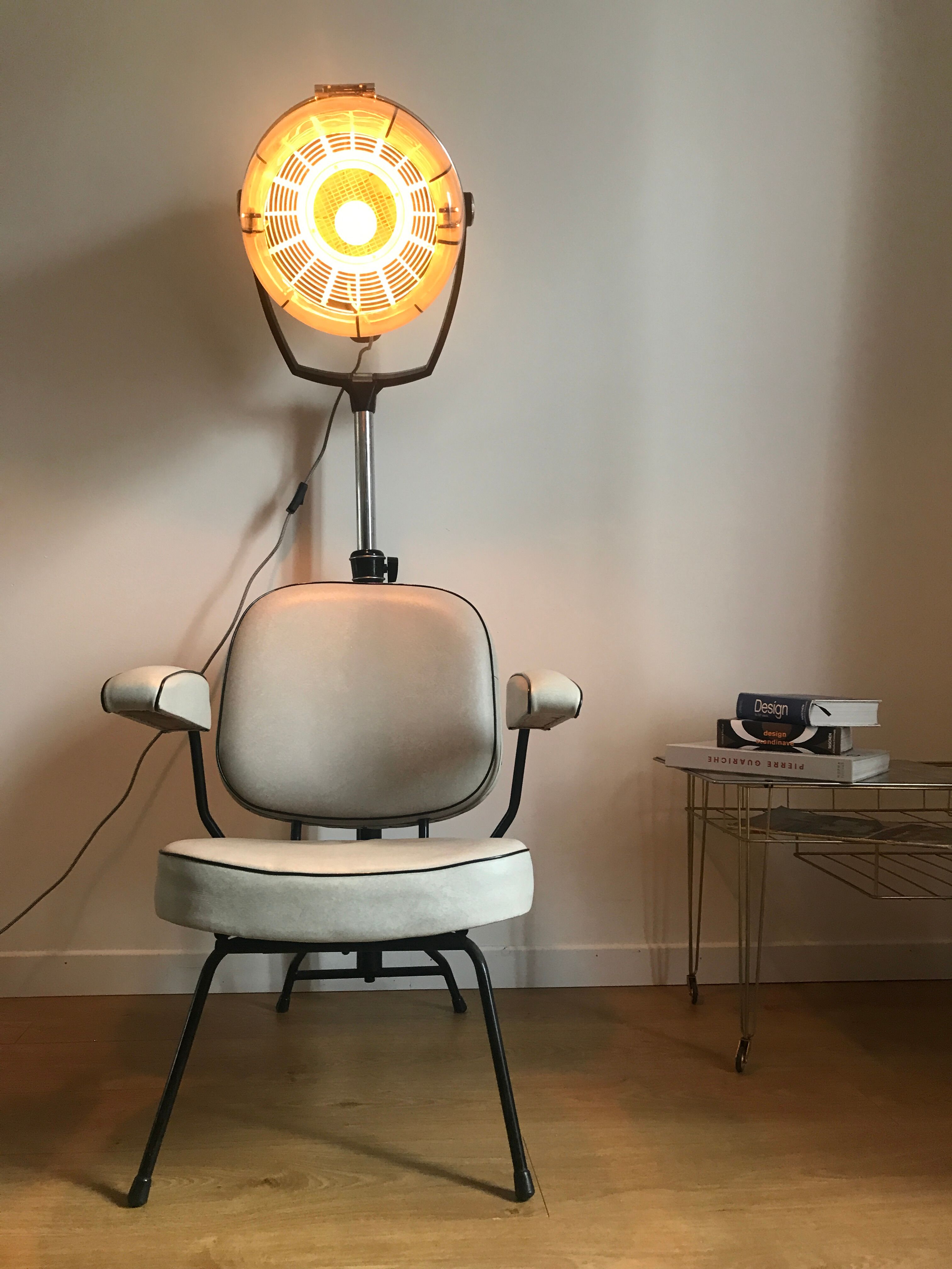 Vintage hairdresser's armchair with helmet transformed into a lamp