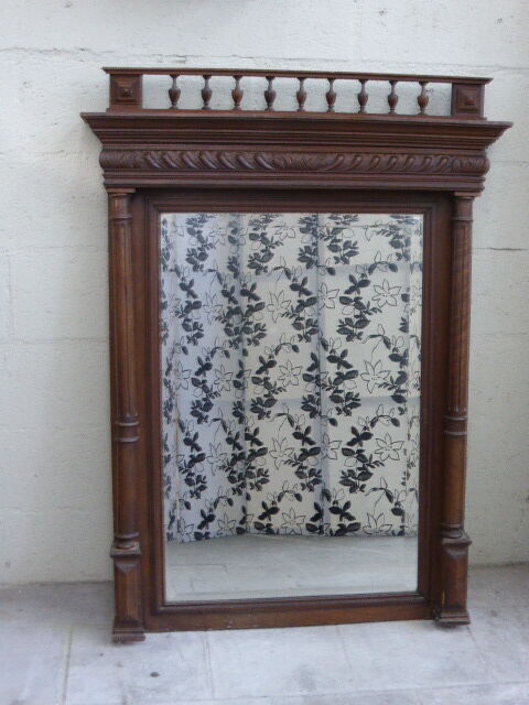 Large mirror beveled Henri II style varnished and carved wooden 128 x 92 cm