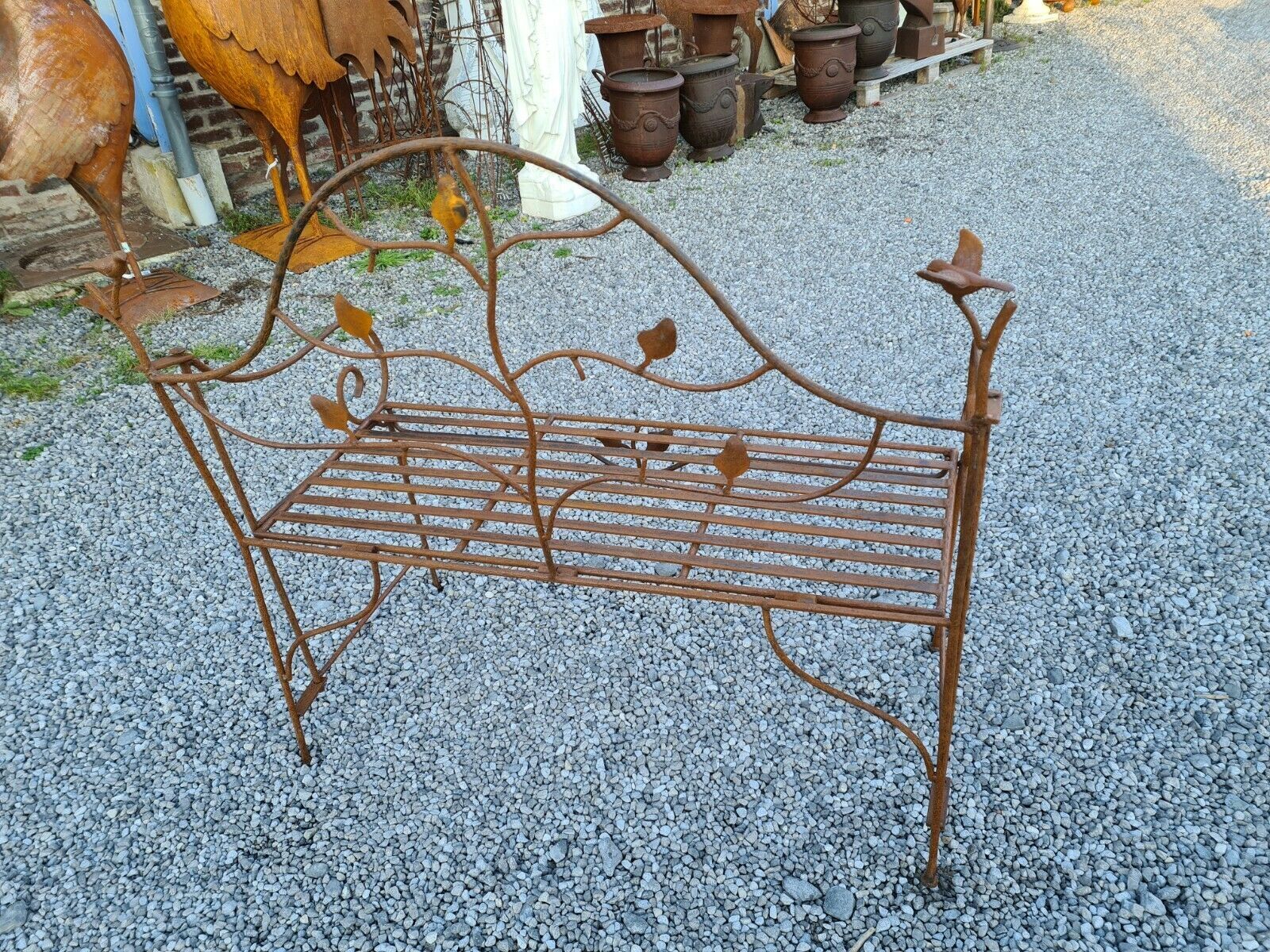 Wrought iron garden bench with birds