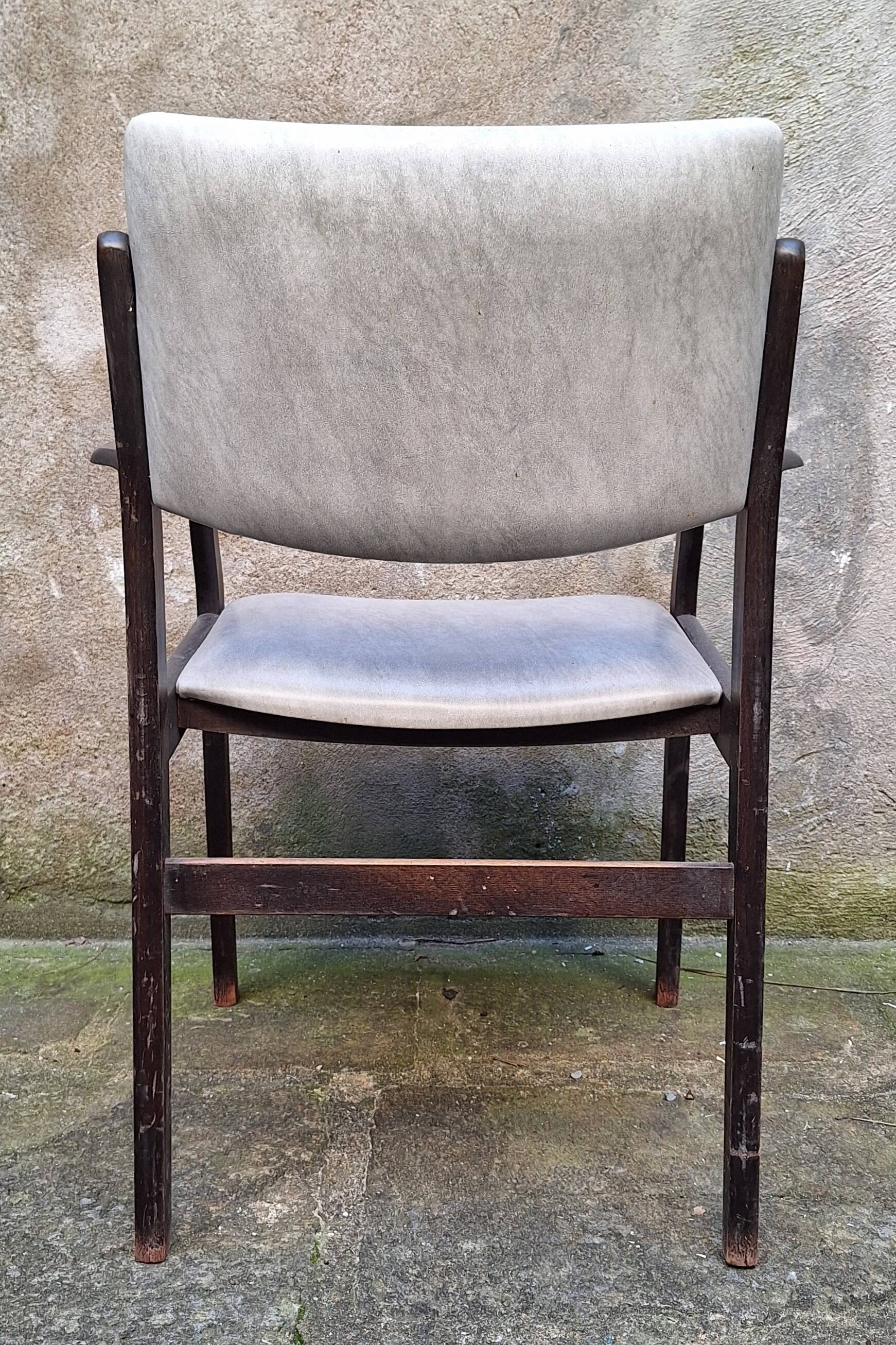 Wooden armchair and faux leather.