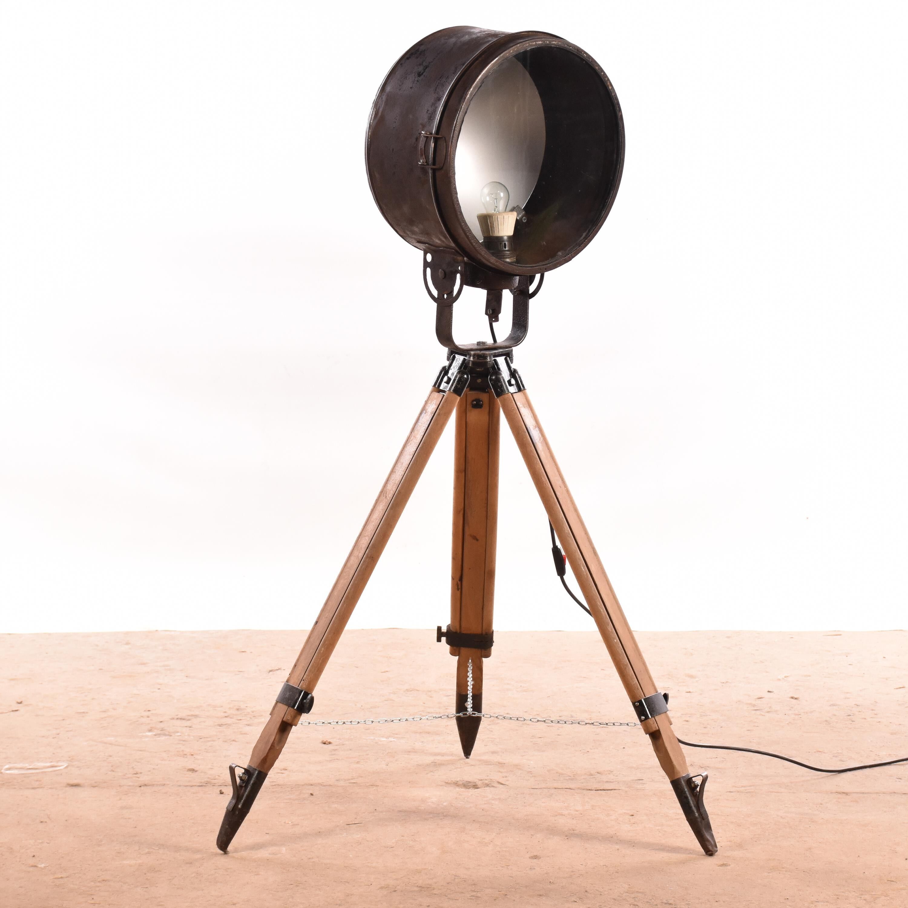 Old industrial spot on wooden tripod floor lamp