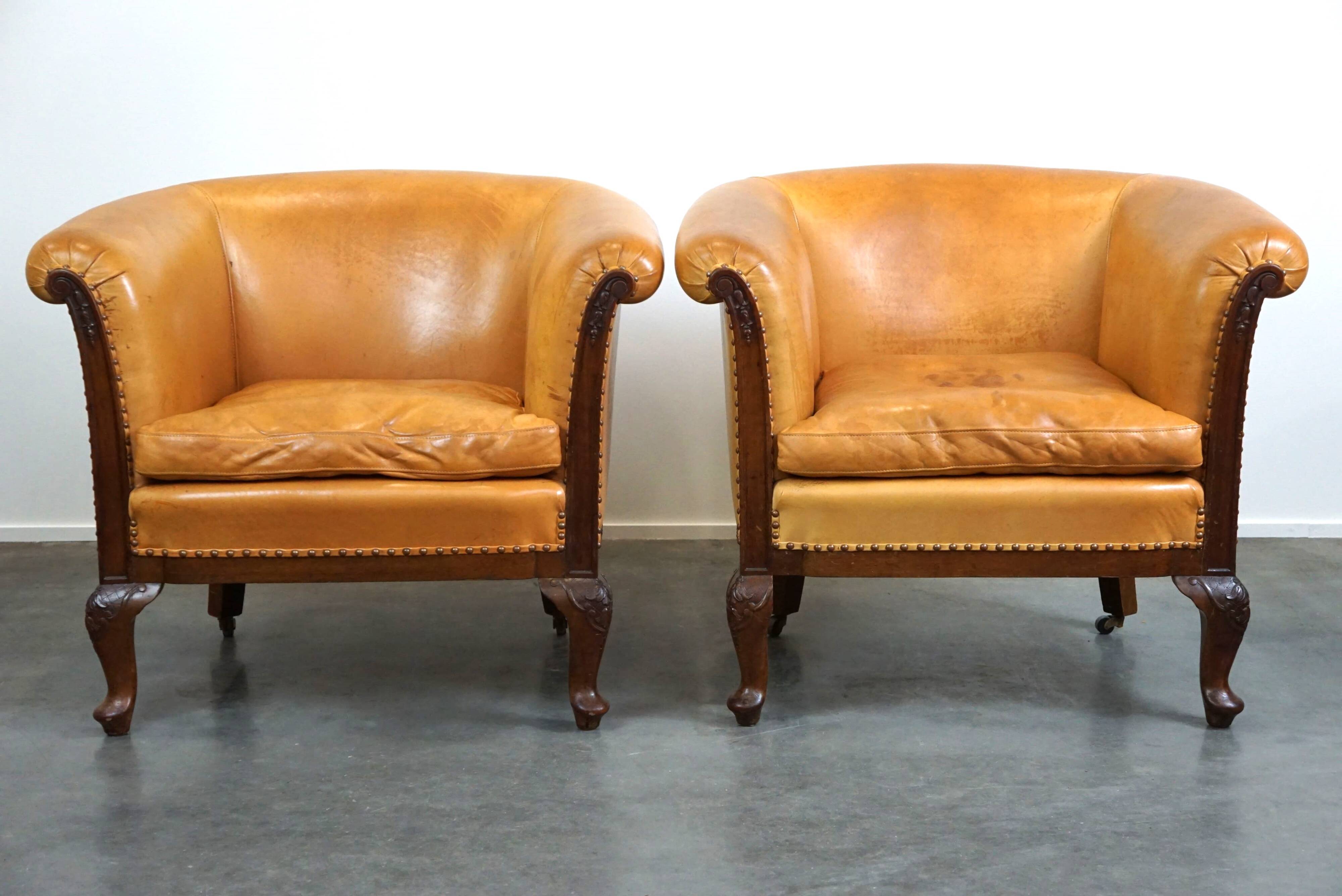 Unique old set of 2 club armchairs and a couch in cognac-colored leather with wheels