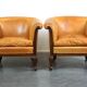 Unique old set of 2 club armchairs and a couch in cognac-colored leather with wheels