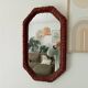 Vintage octagonal mirror in woven rattan.