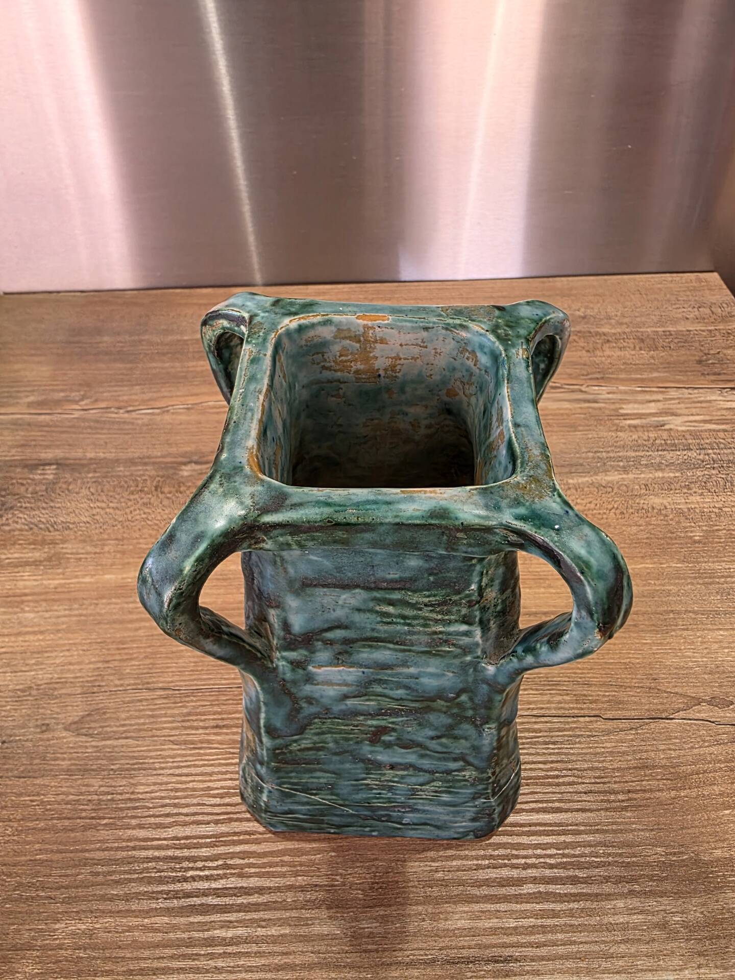 Vintage brutalist ceramic vase with 4 green handles.