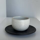White Indonesian ceramic cup and gray saucer