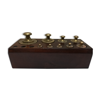 Brass weight series on wooden support