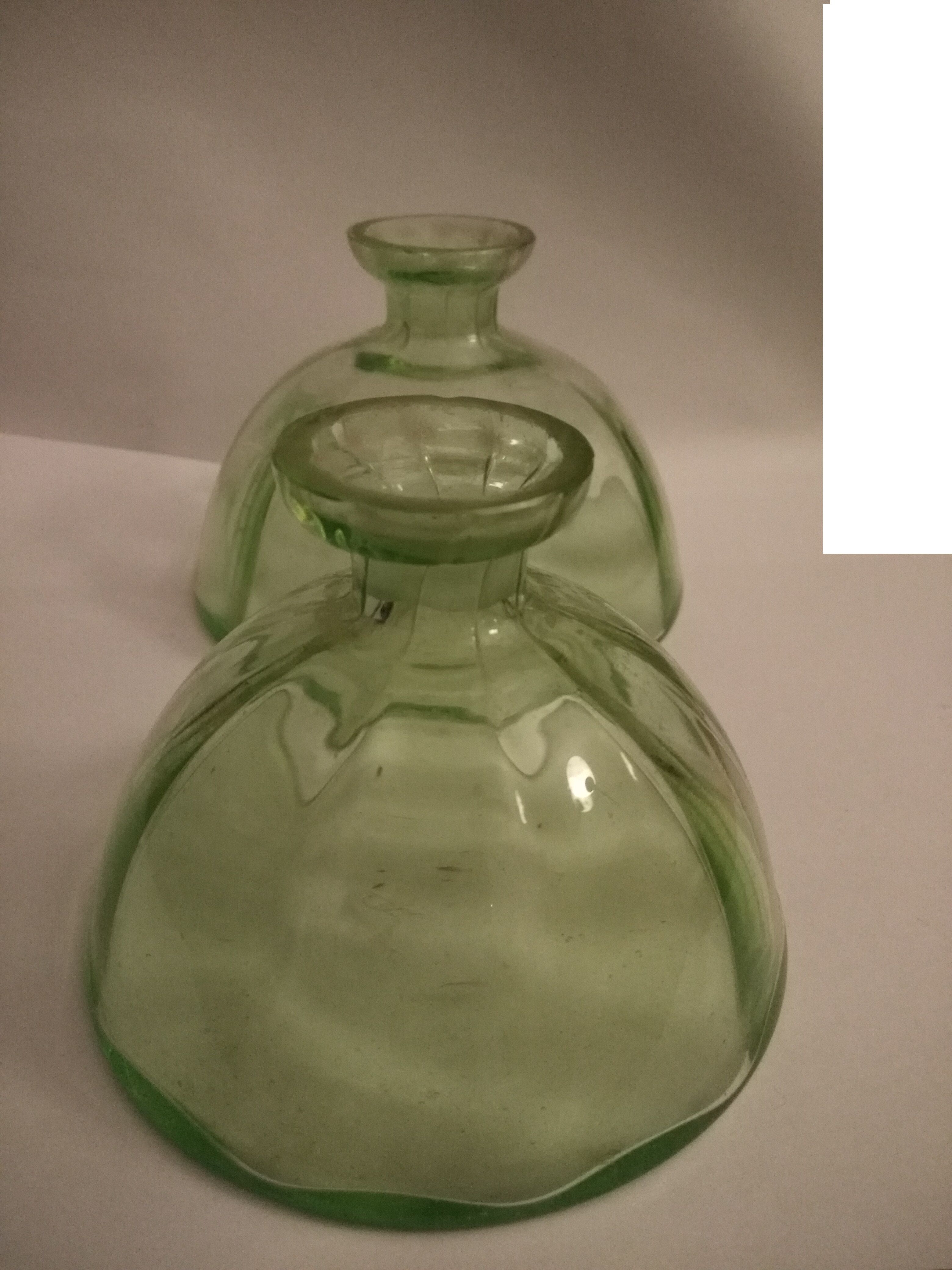 Two bottles in glass, (certainly), surroundings of the 1930s