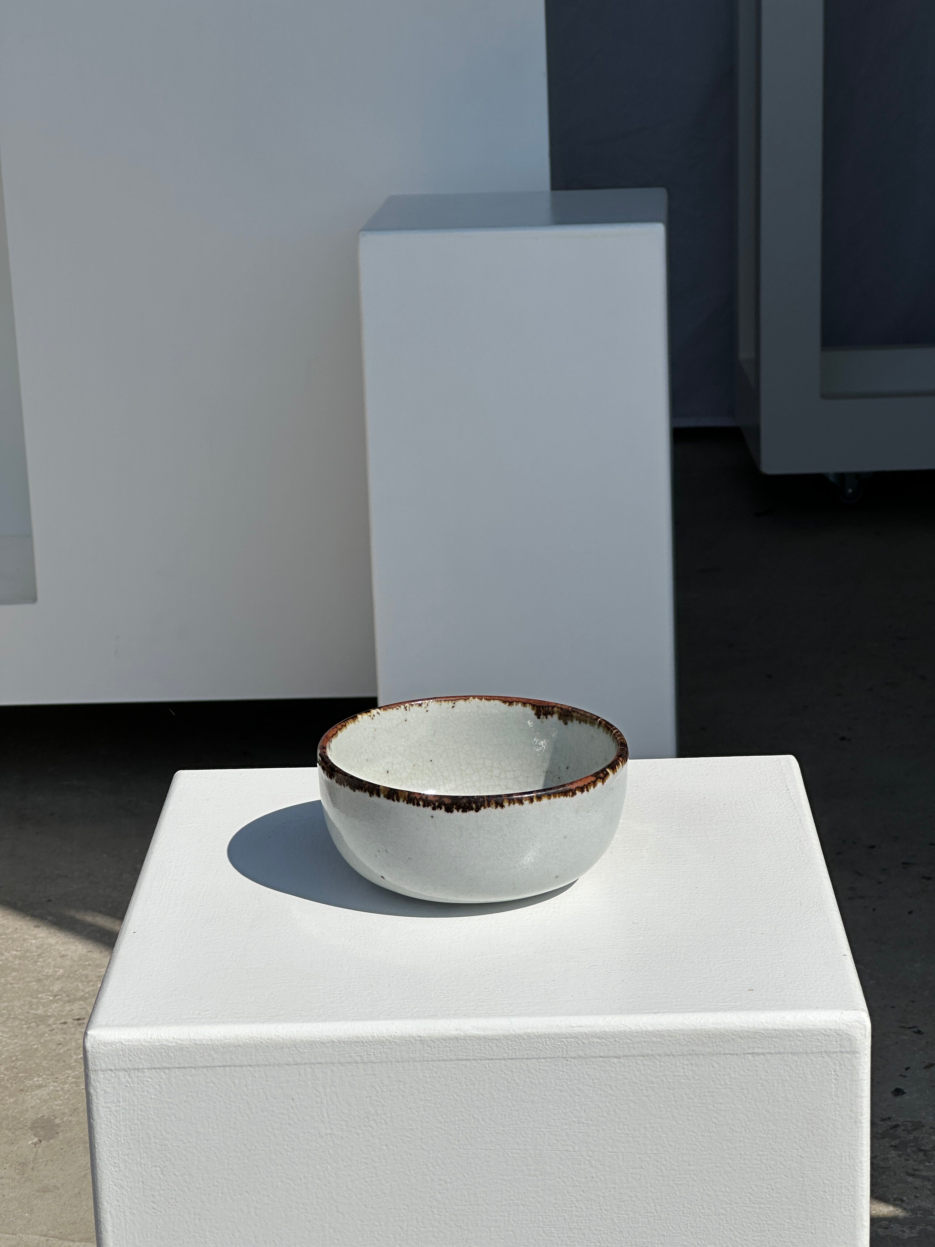 Small white glazed ceramic bowl black edges