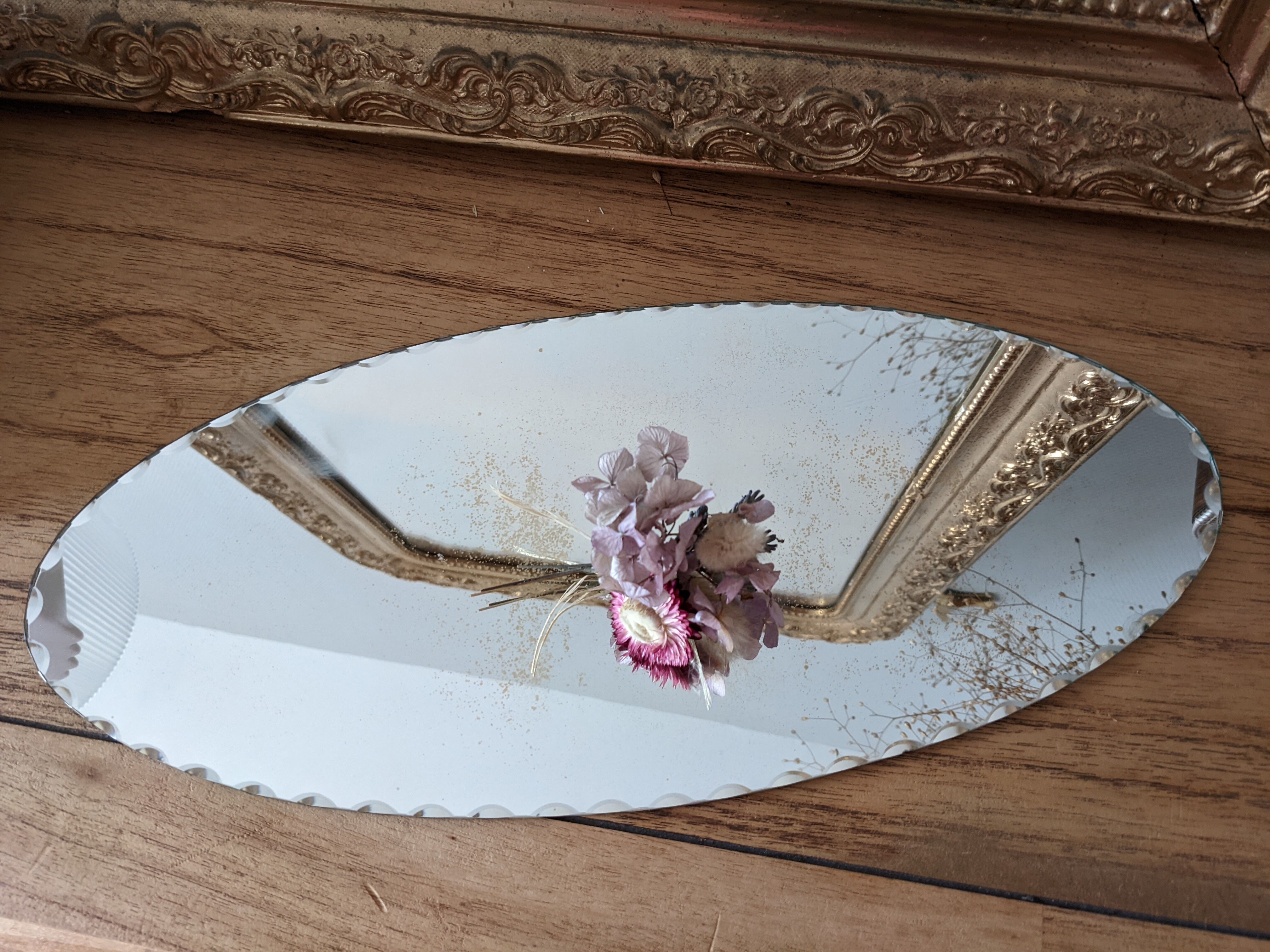 Vintage chiseled bevelled mirror under oval velvet