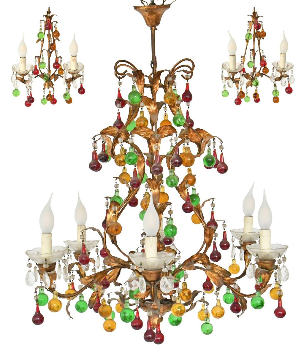 Lustrous chandelier with two wall lights decorated with foliage and pendants.