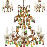 Lustrous chandelier with two wall lights decorated with foliage and pendants.