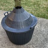 Dame-Jeanne vintage in olive green glass with a basket and black plastic lid.