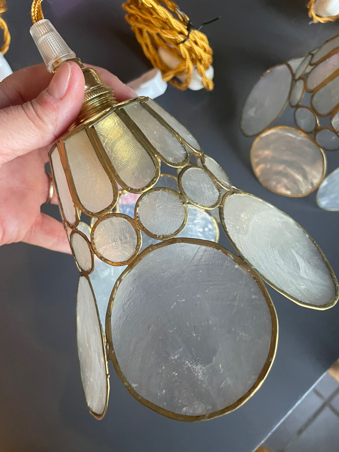 Pair of portable lamps with mother-of-pearl lampshades and brass.