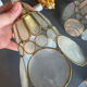 Pair of portable lamps with mother-of-pearl lampshades and brass.
